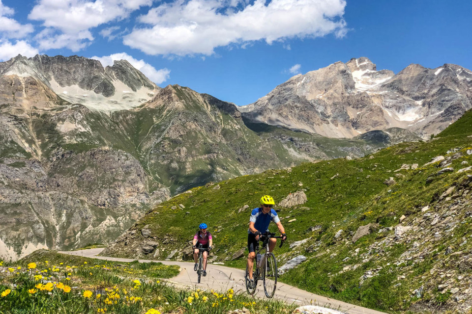 pair of cyclists climb col de l'iseran on French alps cycling holiday with marmot tours