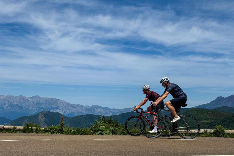 pair of cyclists climb to mirador piedrasluengas picos de europa on marmot tours cycling holiday Spain
