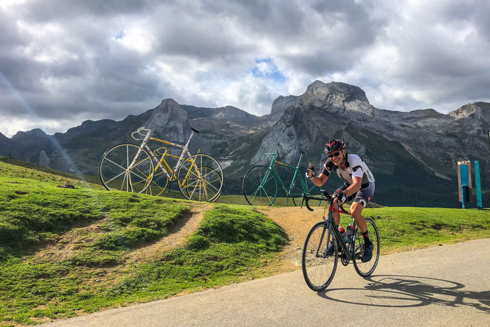 cyclist summiting col D'Aubisque on raid pyrenees cycling challenge with marmot tours