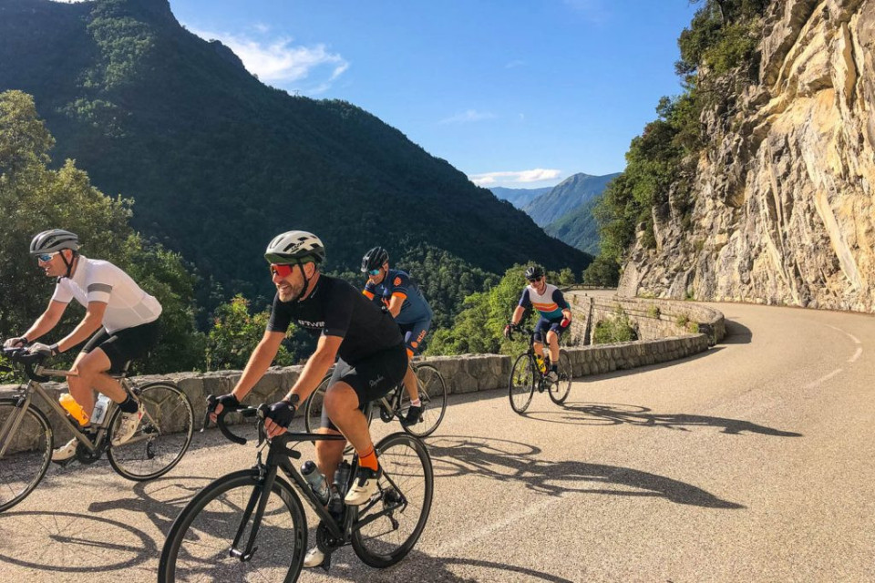 Group of cyclists cycling Col de Turini on Marmot Tours guided cycling holiday Southern Alps
