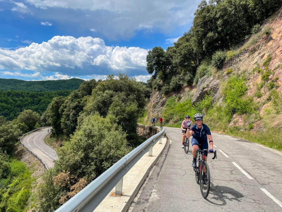 Group of cyclists climbing gradients of Catalonia on Marmot Tours guided road cycling holiday Girona Spain