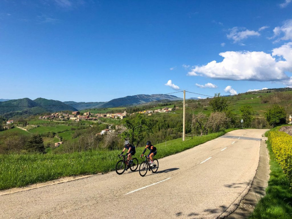 Pair of cyclists enjoying open landscape of Catalonia on Marmot Tours guided road cycling holiday Girona Spain