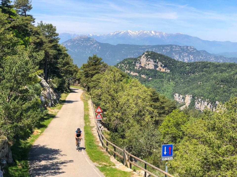 Cyclist climbing in mountains of Catalonia on Marmot Tours guided road cycling holiday Girona Spain