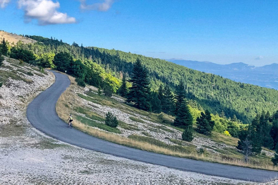 Cyclist on climb to Montagne de Lure on Marmot Tours guided road cycling tour Mont Ventoux Provence France