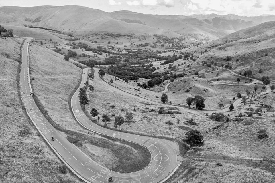 black and white image of cyclists climbing col de peyresourde on marmot tours road cycling holiday French pyrenees