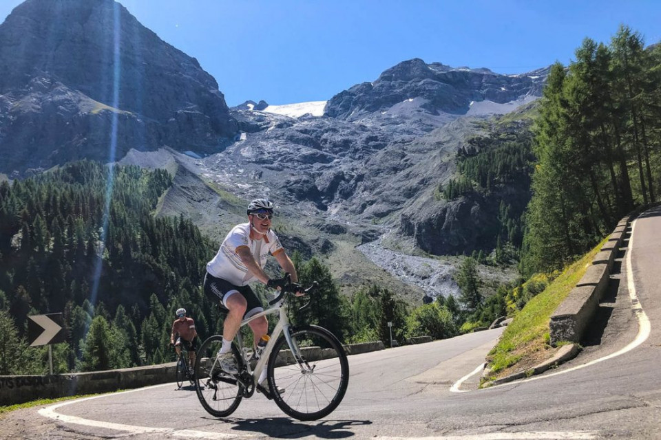 Cyclists smiling climbing Stelvio on marmot Tours guided road cycling tour Italy