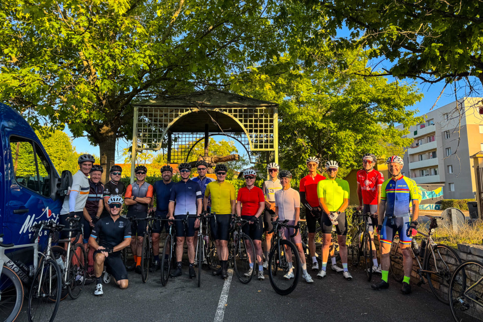 group of cyclists gather for start of raid du Massif Central challenge at hotel entrance with marmot tours