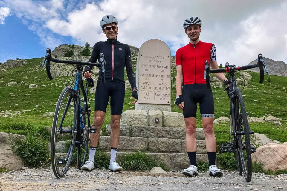 Pair of cyclist smiling for photo at Col de la Cayolle on Marmot Tours guided road cycling tour of Southern Alps