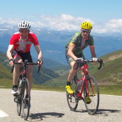 Two cyclists summit the Col de Pailheres on the Marmot Tours Raid Pyrenean