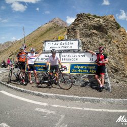 Posing for a photo at the summit of the Galibier with Marmot Tours on the raid alpine road cycling holiday.