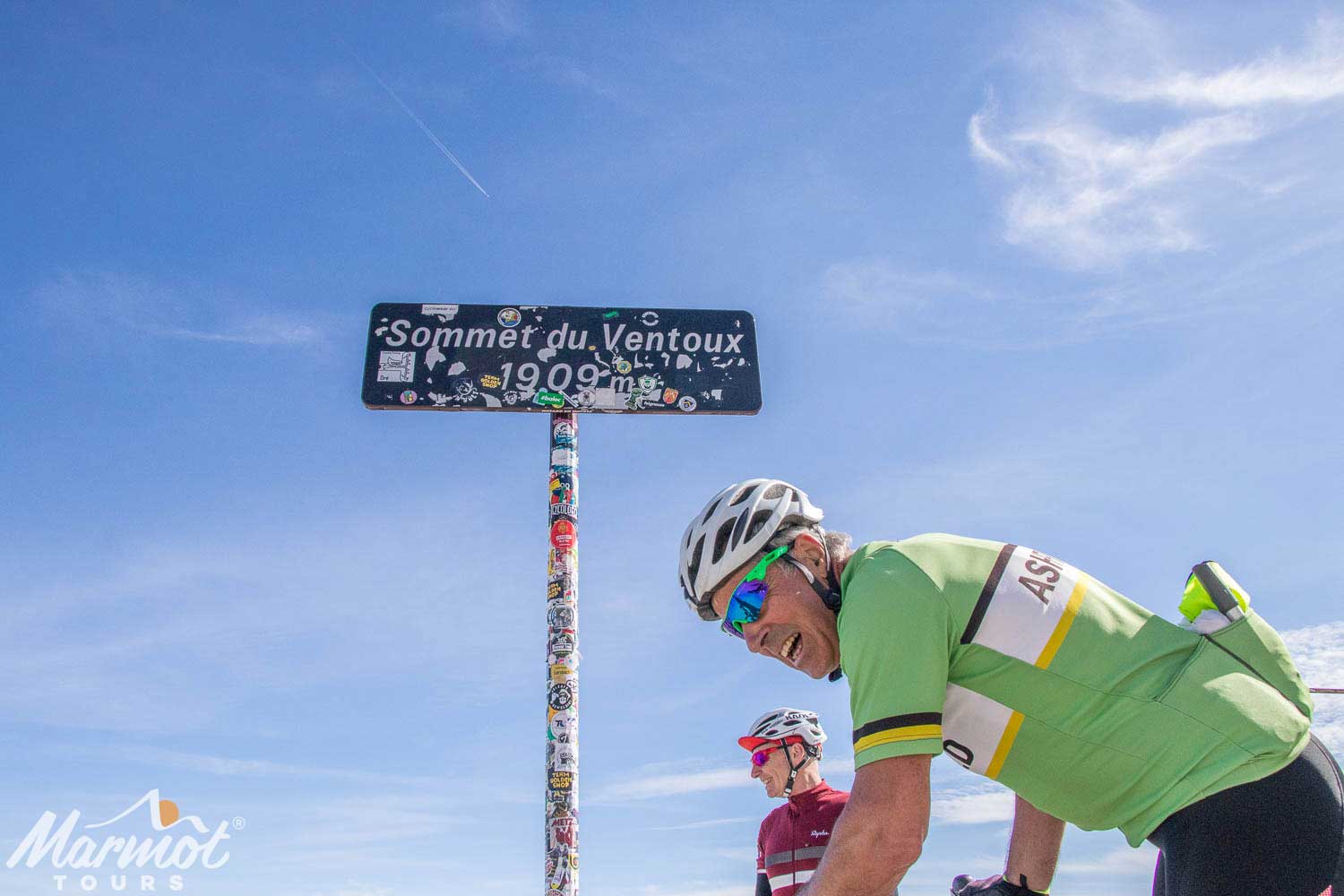 Cyclist celebrating at summit of Mont Ventoux with Marmot Tours road cycling holidays