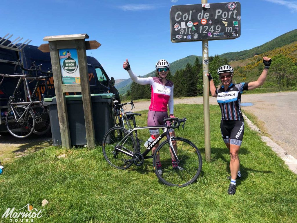 Female cyclists celebrating on Col de Port Raid Pyrenean cycling challenge Marmot Tours
