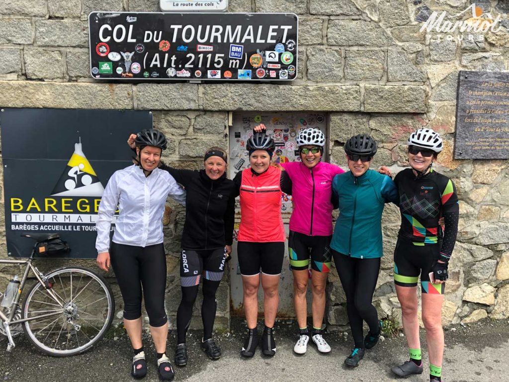 Group of female cyclists on Col Du Tourmalet Raid Pyrenean cycling challenge Marmot Tours