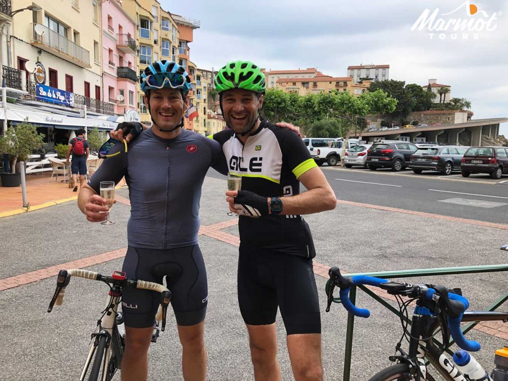 Two cyclists celebrating completing Raid Pyrenean cycling challenge with Marmot Tours