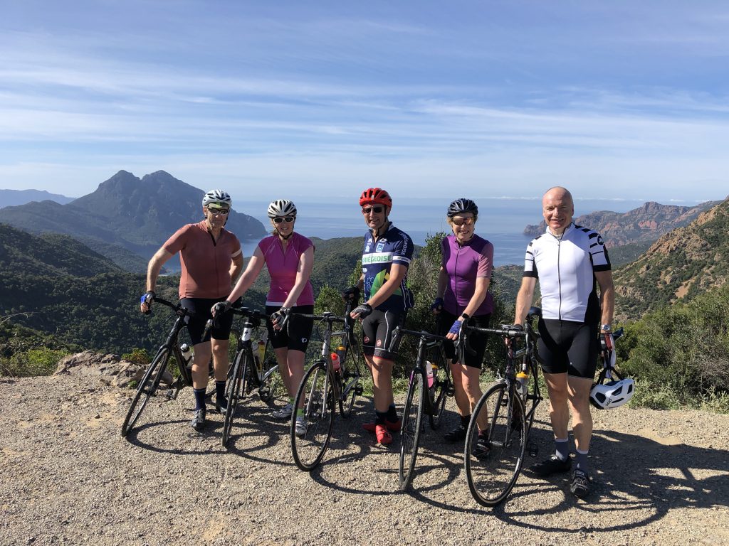 Group of cyclists with coastal view on fully supported road cycling holiday with Marmot Tours