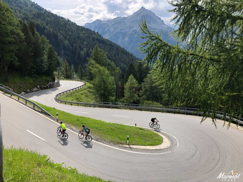Three cyclists on bend with Marmot Tours road cycling holiday in the Italian Dolomites
