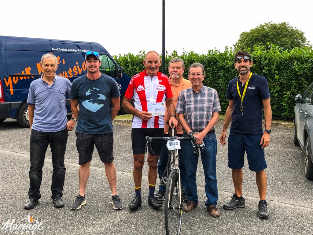 Marmot Tours cyclist presented with certificate for being 10,000th participant of Raid Pyrenean by Cyclo Club Bearnais and Marmot Tours guides on road cycling holiday in Pyrenees