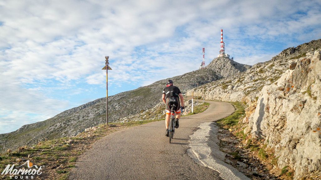 Cyclist approaching summit of Gamoniteiro on Marmot Tours road cycling holiday in Spain Picos