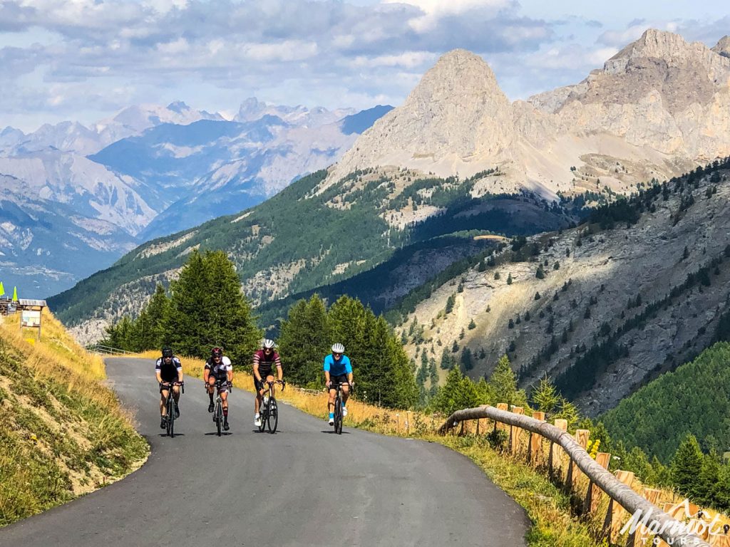 Four cyclists climbing in French Alps wth Marmot Tours European guided road cycling holidays