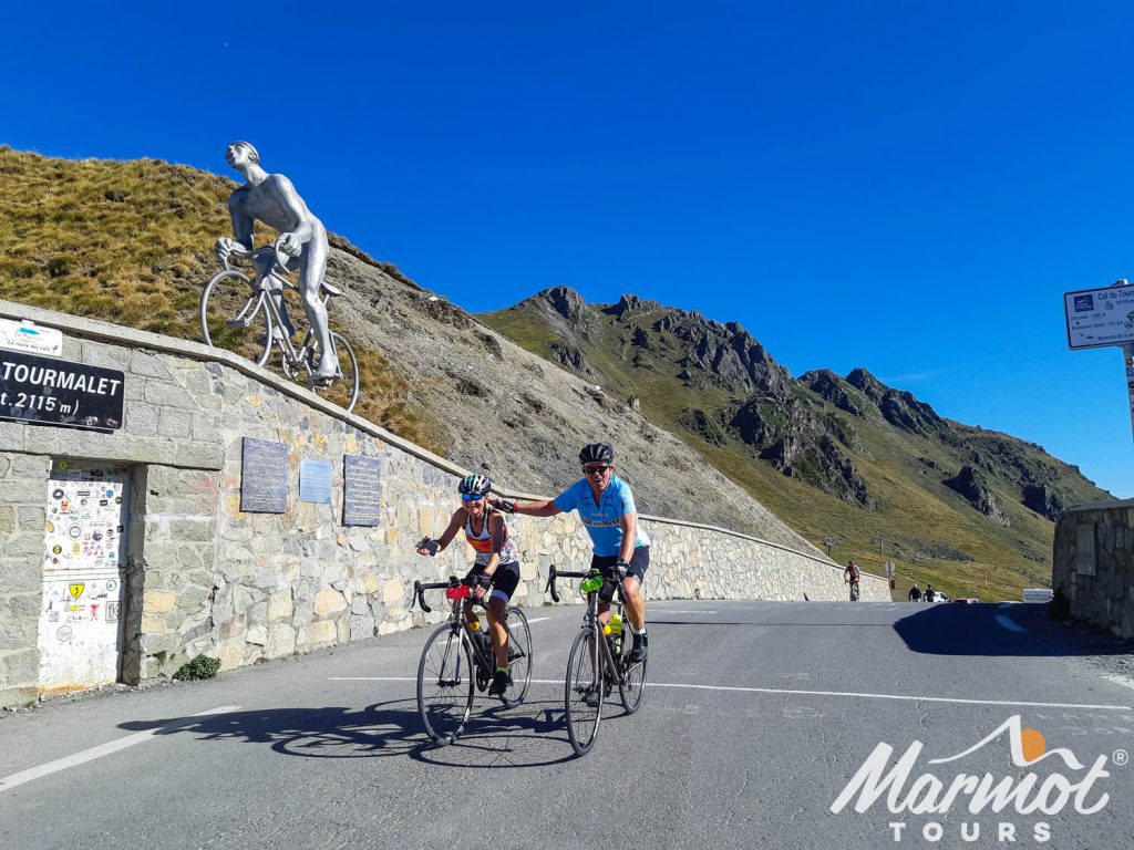 Two-cyclists-summiting-Col-du-Tourmalet-on-Marmot-Tours-road-cycling-holiday-in-the-Pyrenees