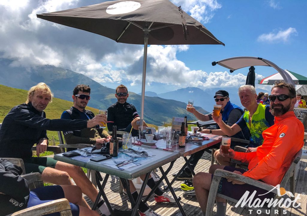 Cyclist enjoying beers in mountain bar on Marmot Tours cycling holiday in the Alps
