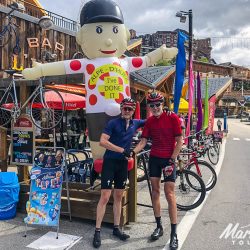 Two cyclist celebrate at Alpe D'Huez summit on Marmot Tours road cycling holiday in the Alps