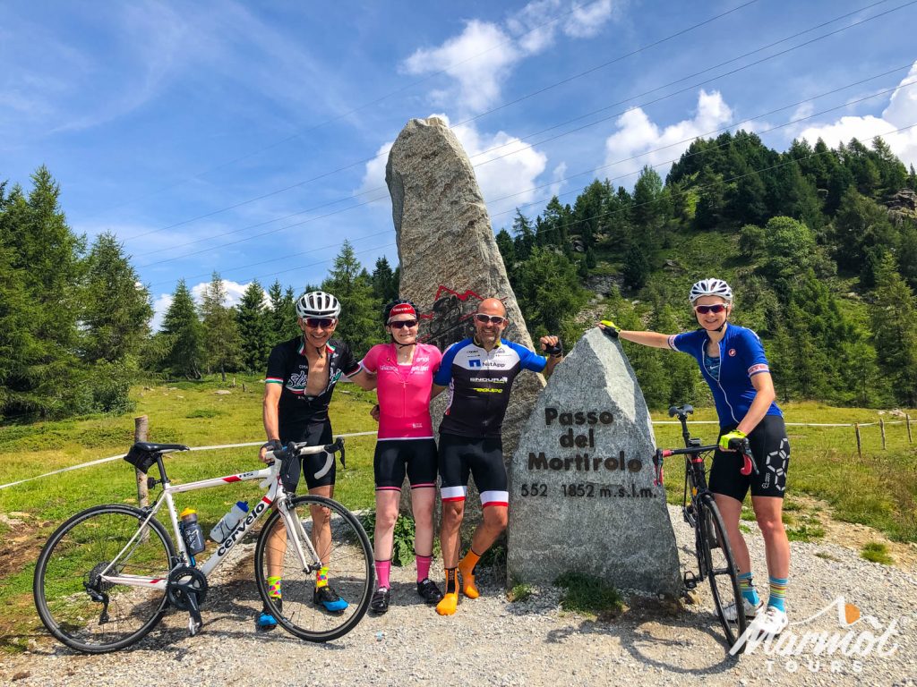 Group of cyclists smiling on Passo del Mortirolo on fully supported cycling holiday in Italian Dolomites with Marmot Tours