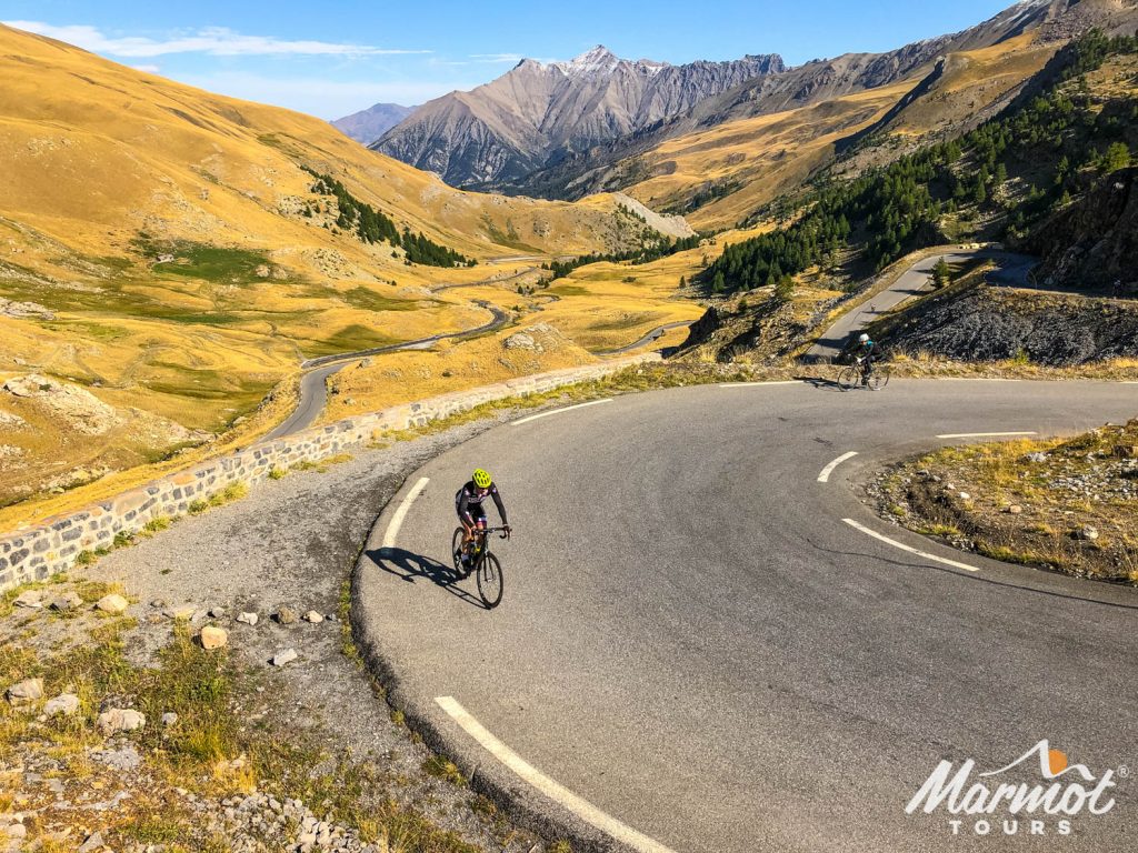 Two cyclists climbing Cime de la Bonette with Marmot Tours Alpine road cycling holidays in Europe