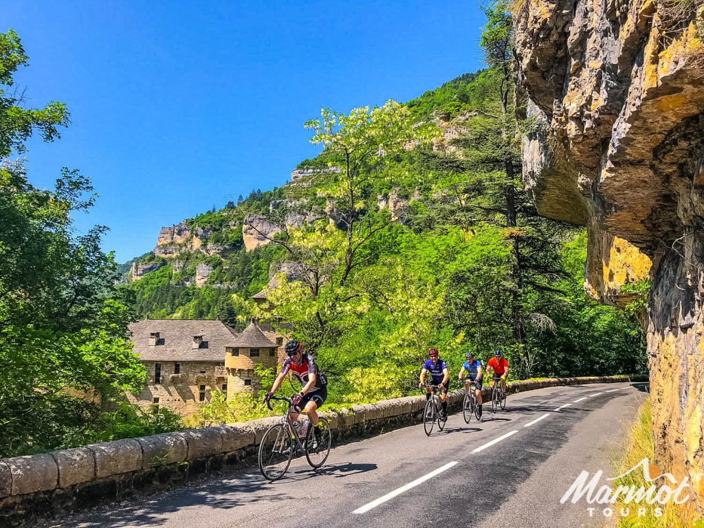 Cyclists and chateau on Marmot Tours guided road cycling holiday southern France Cevennes and Ardeche