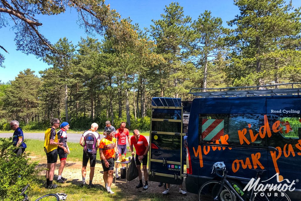Group of cyclists enjoying roadside support of snacks and water on Marmot Tours fully supported road cycling holiday in Catalonia
