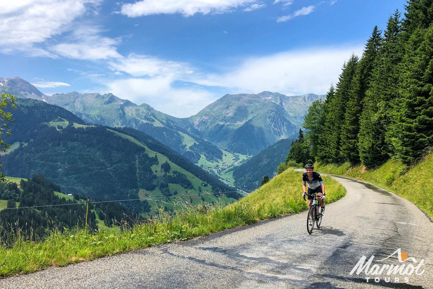 Cyclist climbing in French Alps on Marmot Tours fully supported road cycling holiday challenge