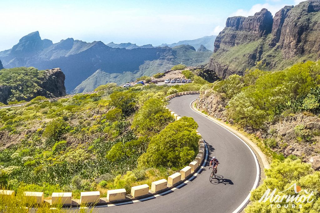 Cyclist climbing through lush landscape on Marmot Tours full support group road cycling holiday in Tenerife