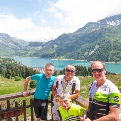 Cyclist enjoying break at Lac Roselend on Marmot Tours Raid Alpine cycling challenge