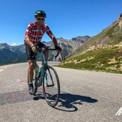 Cyclist enjoying a climb on Raid Alpine with Marmot Tours guided road cycling holidays France
