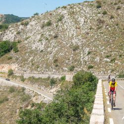 Pair of cyclists climbing out of Nice on Marmot Tours Raid Alpine cycling challenge