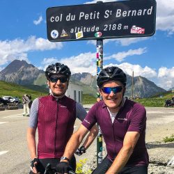 Pair of cyclist happy at the Col du Petit St Bernard on Marmot Tours guided cycling tour of French Alps