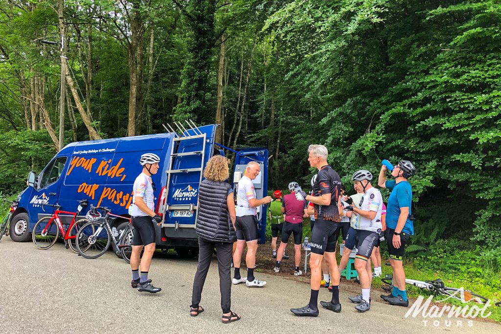 Cyclists and Marmot Tours guide gather round support van on Raid Pyrenean cycling challenge