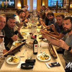 Group of cyclists enjoying dinner on Marmot Tours full support road cycling tour of Dolomites Italy