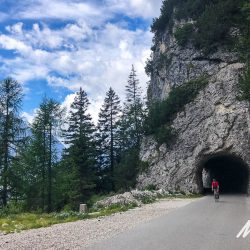 Cyclist and tunnel climbing Mangart Saddle on Slovenia road cycling holiday guided by Marmot Tours