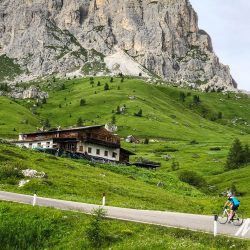 Female cyclist nearing summit of Passo di Giau on Marmot Tours Raid Dolomites cycling challenge