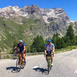 Pair of cyclists including Mike Tindall rugby playeron Marmot Tours Raid Alpine cycling challenge French Alps