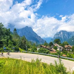 Cyclists climbing hairpin bend with stunning mountainous backdrop on Marmot Tours fully supported road cycling tour of Dolomites Italy