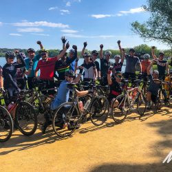 Group of cyclists at Lake Banyoles on Marmot Tours fully supported road cycling holiday Girona Catalonia Spain
