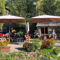 Group of cyclists enjoying sunny cafe on Marmot Tours fully supported road cycling holiday in Catalonia Girona cycling tour Spain