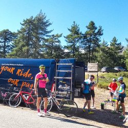 Group of cyclists enjoying snacks from Marmot Tours support van on Raid Corsica cycling challenge