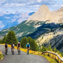 Group of cyclist enjoying beautiful climb through mountains of Southern Alps on Marmot Tours fully supported road cycling holiday