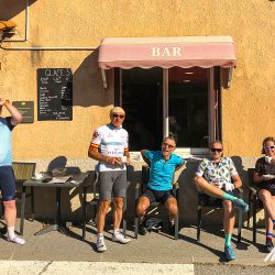 Cyclist enjoying coffee outside bar on Marmot Tours guided road cycling tour not Ventoux Verdon Gorge Provence France