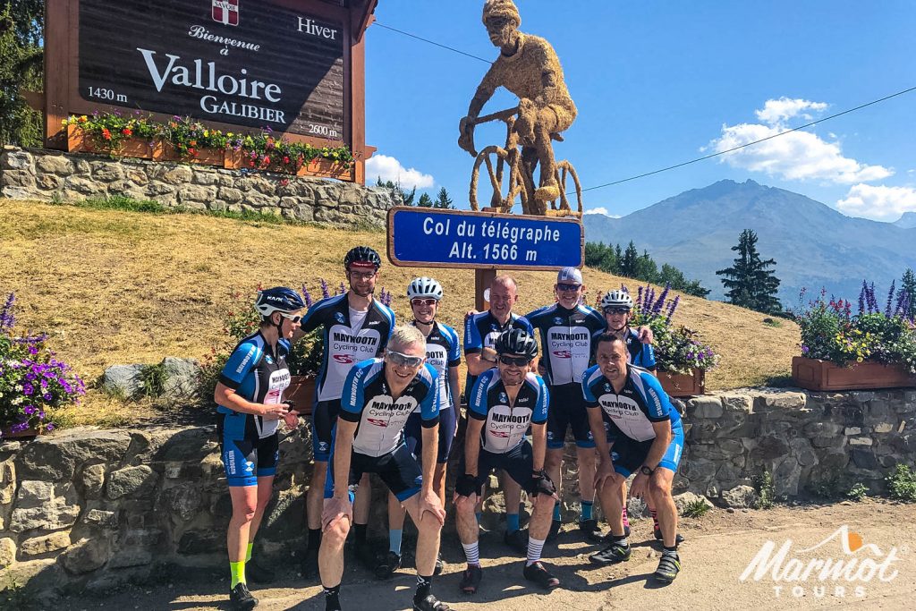 Group of cyclists smiling at Col du Télégraphe on Raid Alpine cycling challenge with Marmot Tours