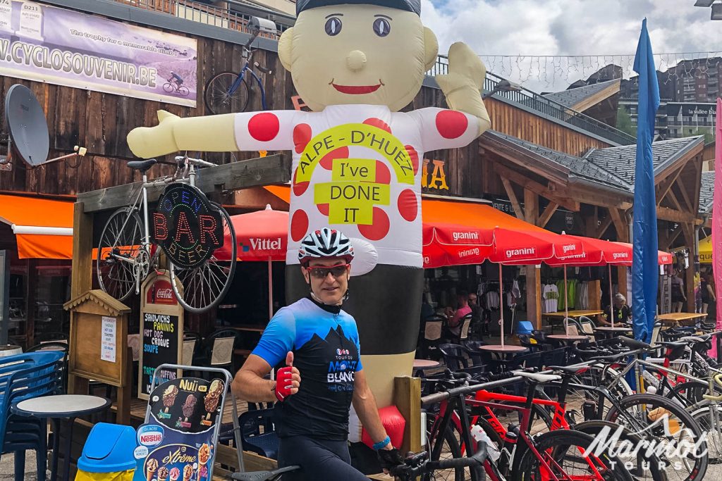Cyclist thumbs up at Alpe D'Huez on Marmot Tours guided road cycling holiday