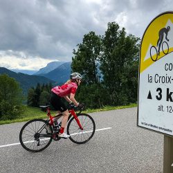 Female cyclist on cold de Croix-Fry climb on Marmot Tours guided cycling tour Northern French Alps
